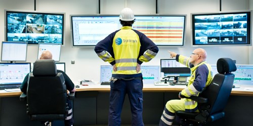 Three Workers at Central Control Room in Knapsack