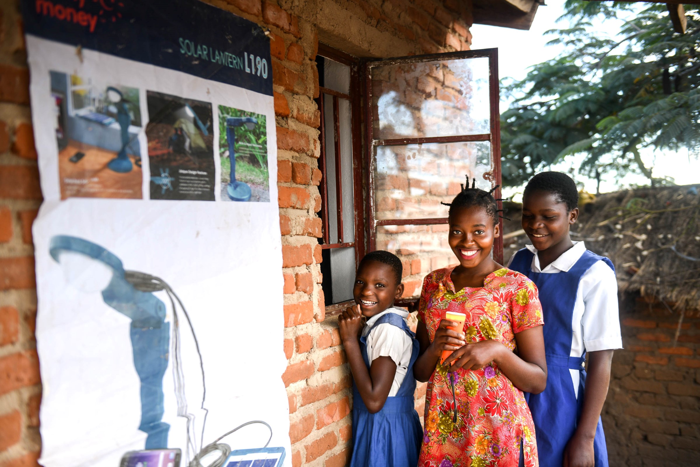 Picture of three girls standing outside smiling