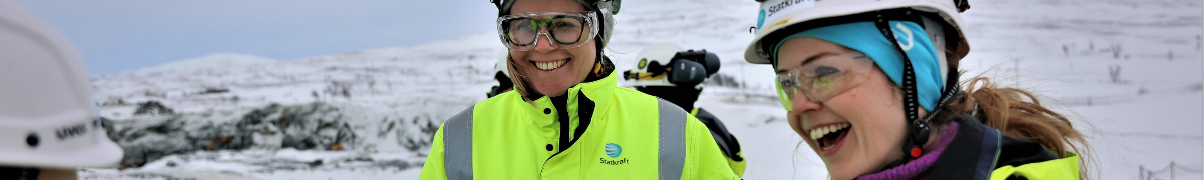 Two woman wearing safety gear and laughing